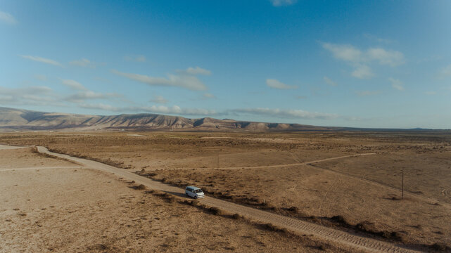Car driving along road in desert