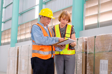 Supervisors and employees check stock in the warehouse.