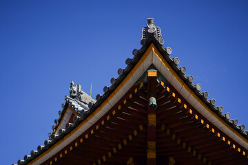 Fototapeta na wymiar Japanese style decorative clay roof of the temple