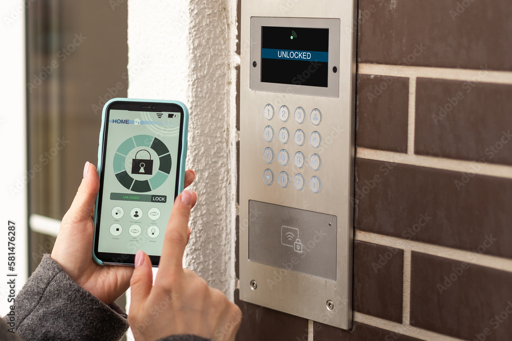 Aufkleber smiling woman setting home security system with help of mobile application.