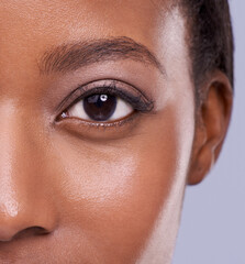 Zooming in on beauty. a beautiful african woman against a purple background.