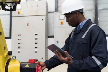 Automated manufacturing industries Male engineer worker maintenance industrial automatic robotic arm machine for manufacturing in workshop. Male technician worker repair robotic arms in factory