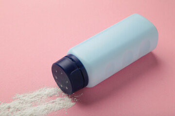 Baby powder on pink background. Baby cosmetics. Space for text