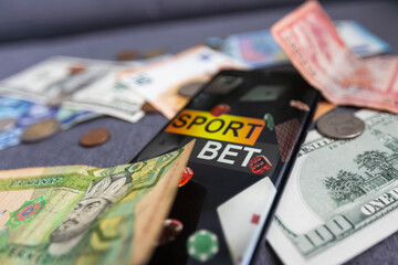 dollars and euros, smartphone with sports bet application