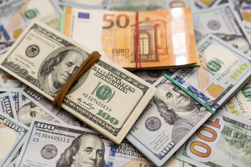 Fototapeta na wymiar 200 Euro banknote next to 50 euros on top of one hundred dollar bills. Trading Euro with Dollar