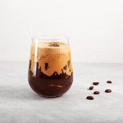 Iced coffee Latte or Cappuccino coffee drink on grey background, close-up