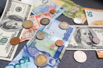 Business and finance concept. Monetary background. US and EU banknotes and coins, Paper dollars, euros and coins scattered in chaotic order. Business and finance concept