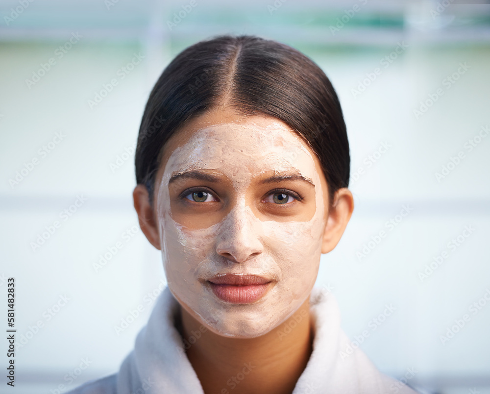 Wall mural Skin rejuvenation. Portrait of an attractive young woman wearing a facial mask.