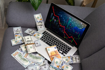 Stock Market Chart on Screen with Dollars and Euros on Background.