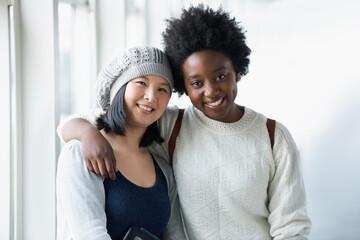 Obraz premium Friends for Life. Portrait of two University students hugging and smiling.