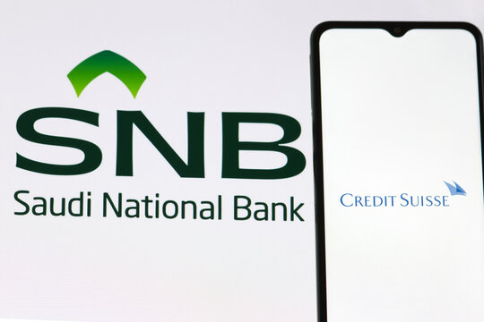 Credi Suisse Bank logo, on background of SNB ( Saudi National Bank) symbol, Warsaw, Poland, March 15, 2023