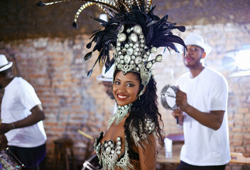 The rhythm of the night. an ethnic female samba performer and her band mates.