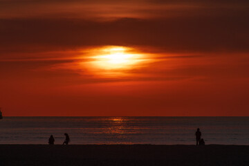 Sunset at Chinchorro beach, with the red sun slowly going down