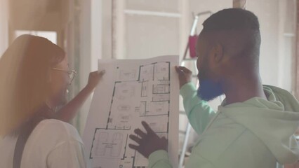 African-American couple looking to blueprints of new house. Realtime - Powered by Adobe