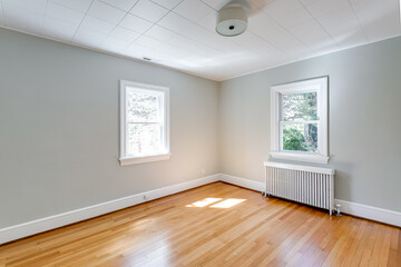 Fototapeta na wymiar Sunny Spring Empty Bedroom Interior with Hardwood Floors