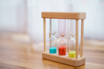 Colorful hourglasses with blurred background cute concept