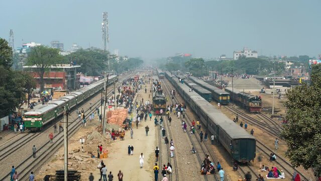 Timelapse view of passengers boarding and climbing onto the roof of trains at railway station in the suburbs of Dhaka, the capital of Bangladesh and one of the world's most densely populated cities.
