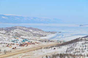 Aerial View of Frozen Lake Baikal and Small Colorful Village in Russia