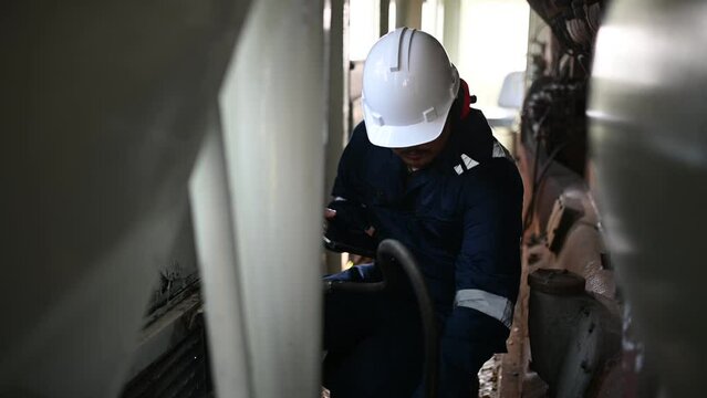 Engine engineer inspecting large machines in factory,Railway engine maintenance technician,engine repair mechanical manager