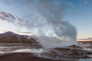 Steaming vent on the El Tatio geyser field in the high Andes of northern Chile just before sunrise
