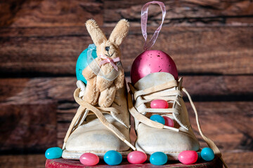 vintage 67 year old white baby shoes with original laces decorated for Easter with jelly beans and...