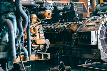 Automotive mechanical assembly, engine, transmission, suspension and breaking system. Automotive engine assembly line is in production. Car Assembly by parts, Diesel locomotive engine in a repair