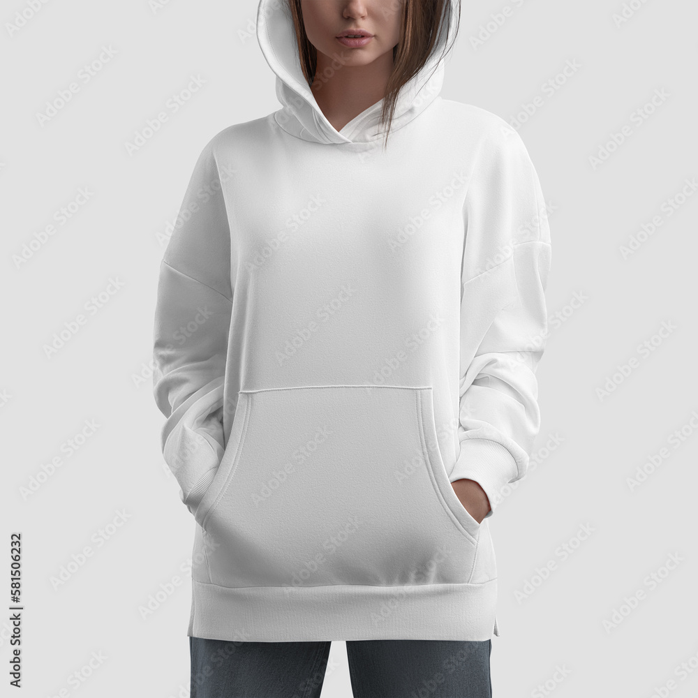 Wall mural Mockup of white long hoodie on girl with hands in pockets, shirt with side slits, clothes isolated on background, front. - Wall murals