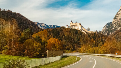 Fototapeta premium Alpine autumn or indian summer view with fortress Hohenwerfen and the Tennengebirge mountains near Werfen, Salzburg, Austria