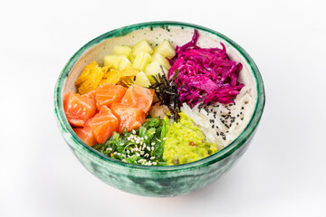 Bowl with salmon, avocado, red cabbage, nachos, cucumber, nori, white and black sesame, chuka. Round green bowl on a white background. Close up 3/4