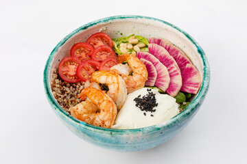Poke bowl with shrimp, quinoa, poached egg, celery, cherry tomatoes, herbs, pine nuts and sesame seeds. Green round bowl on a white background. Close up 3/4