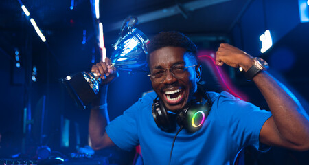 Happy American African Professional gamer, winner rejoices in victory of online games tournaments...
