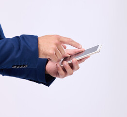 Man, phone in hands and typing in studio for communication with network connection on social media. Hand of male with smartphone for internet search, mobile app and online chat on a white background