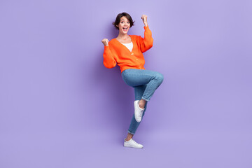 Fototapeta na wymiar Full length photo of young funky girl overjoyed fists up wear trendy clothes celebrate her new project victory isolated on violet color background
