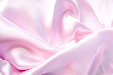 Abstract background of luxury pastel pink fabric, folded textile or liquid wave or wavy folds silk...