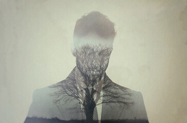 Roots of introspection. Composite image of a well-dressed man superimposed on an image of nature.