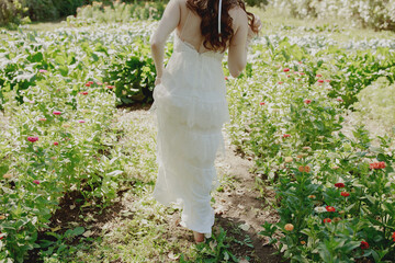 Bride walking through a garden of flowers