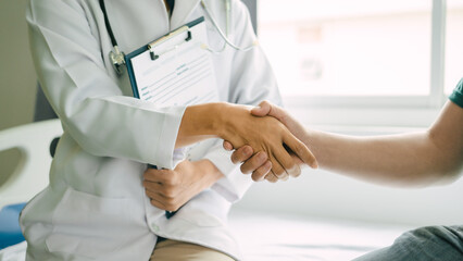 Shaking hands, Male patient consulting a medical specialist at hospital.