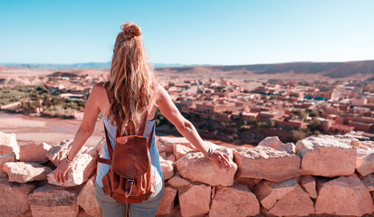 Ait Ben Haddou in the Atlas mountains of Morocco and woman tourist looking at the view