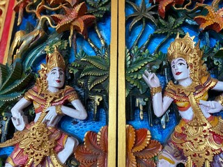 Colorful carving balinese door with ramayana story figure on pattern