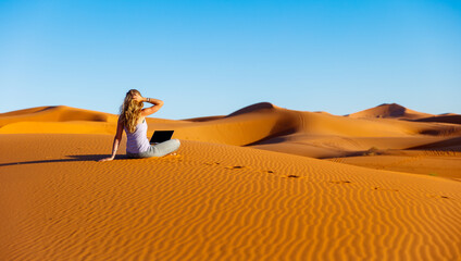 Woman with computer in the desert