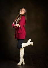 happy smiling young asian woman smiling with her arms crossed wearing a red jacket