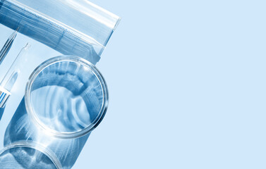 serum in petri dishes on light blue background cosmetic research concept