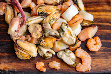 seafood salad shrimp, mussel, scallop, octopus healthy meal food snack on the table copy space food background rustic top view pescatarian diet