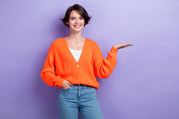 Portrait of nice positive girl toothy smile arm palm hold demonstrate empty space isolated on...
