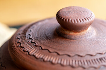Clay pot with a lid top view close-up. Serving soup in a restaurant. Clay, ceramic dishes. Pottery. Selective focus, defocus