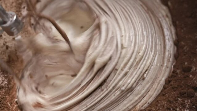 Pie dough kneading with cocoa using automatic mixer closeup. Tasty bakery desert cake preparation with chocolate