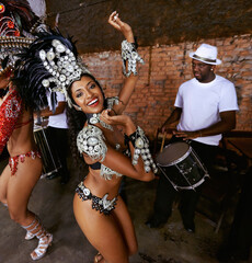 Dont upset the rhythm. a beautiful samba dancer performing in a carnival with her band.