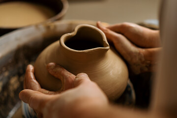 Pottery workshop a potter teaches a student to sculpt a jug from clay a couple is engaged in pottery