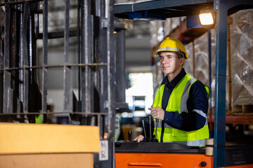 Man wear safety helmet driver forklift warehouse in factory. Male worker industrial operate. control loading container box. logistics export import concept.