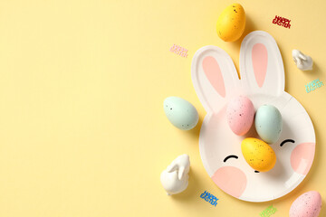 Happy Easter banner template. Cute bunny head shaped plate with colorful Easter eggs and decorations on pastel yellow background